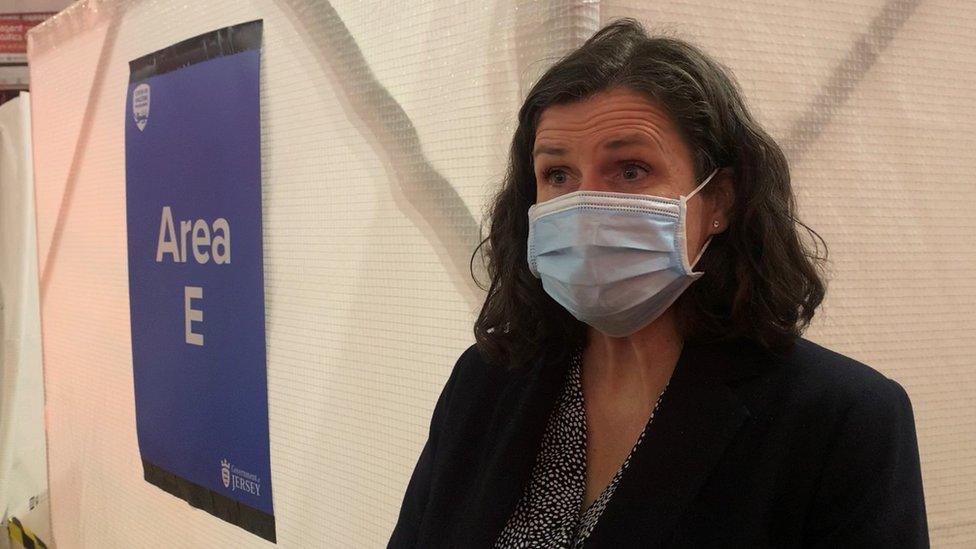 woman standing in front of area e sign