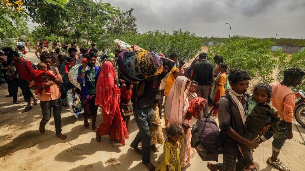 Indian people arriving at school converted into temporary shelter