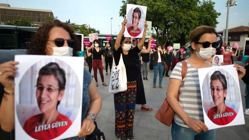 Demonstrators hold pictures of HDP lawmaker Leyla Guven