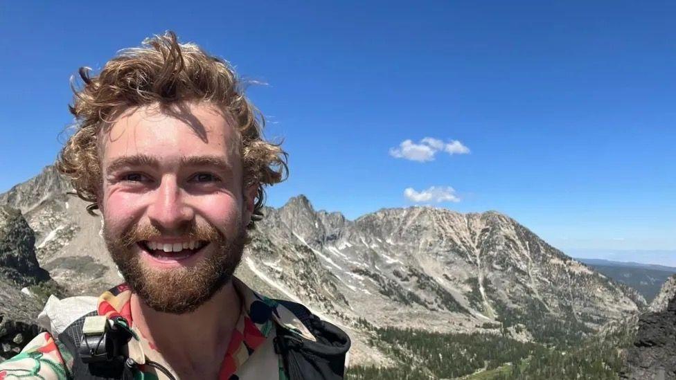 Piers Ellison taking a selfie in front of a mountain 