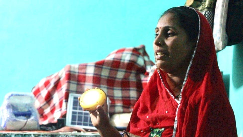 Santosh Kanwar showing products to local villagers