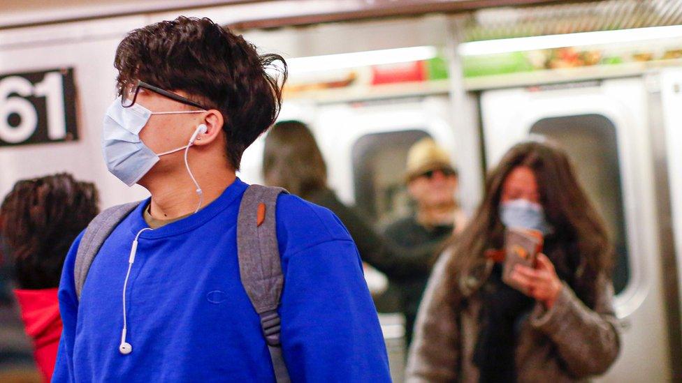 A man wears a face mask as he rides the subway on March 8, 2020 in New York City