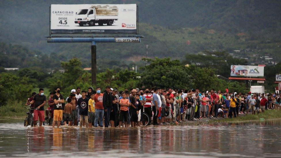 People look at a flooded street during the passage of Storm Eta, in Pimienta, Honduras November 5, 2020