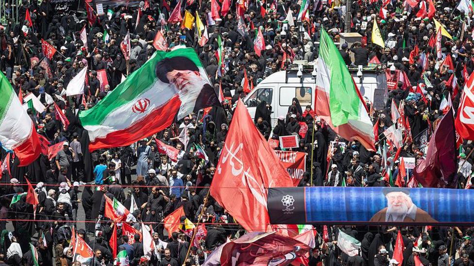 Huge crowds in Mashhad as Iran's late supreme leader is buried