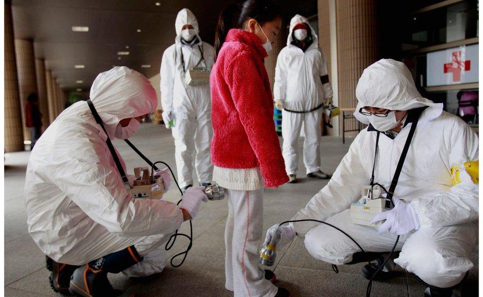 In this March 2011 file photo, a young evacuee is screened at a shelter for radiation from the tsunami-ravaged Fukushima Dai-ichi nuclear plant in Fukushima