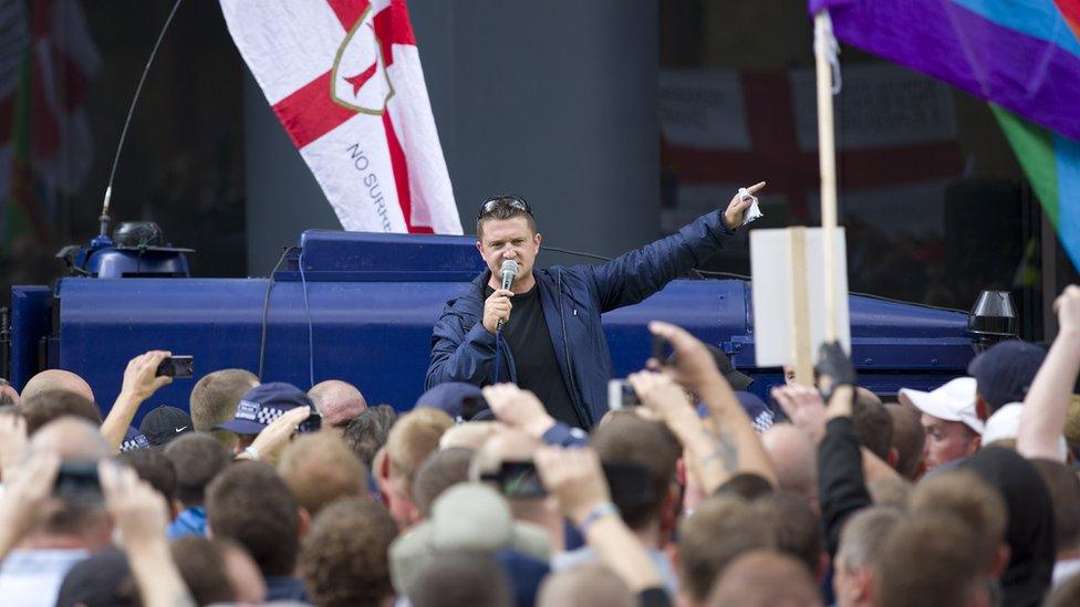 Leader of the right-wing EDL (English Defence League) Tommy Robinson (C) aka Stephen Yaxley-Lennon speaks to his followers at a protest in central London on September 7, 2013.