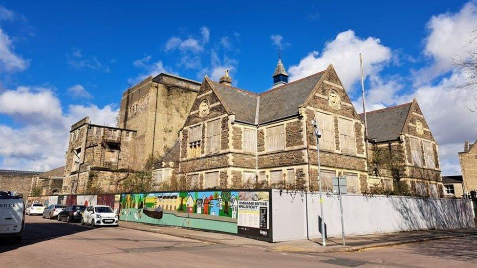 Imposing Mechanics' Institute building surrounded by fencing