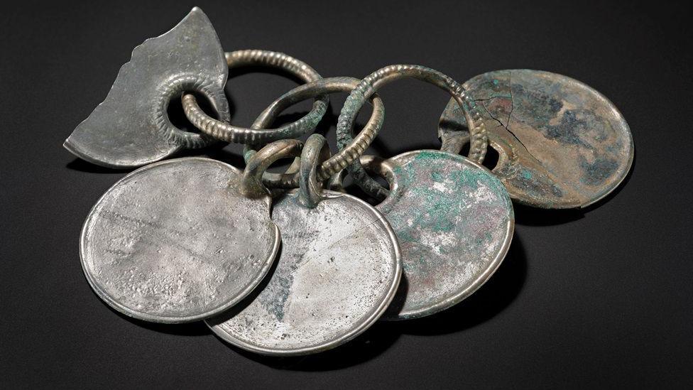 A Bronze Age rattle which has been conserved and clean and has a silver colour to it