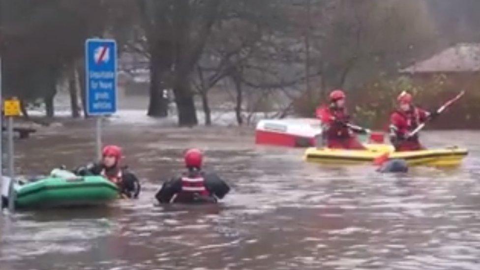 Mountain rescue volunteers rescue an elderly man from a near-submerged car in Mytholmroyd, Calderdale