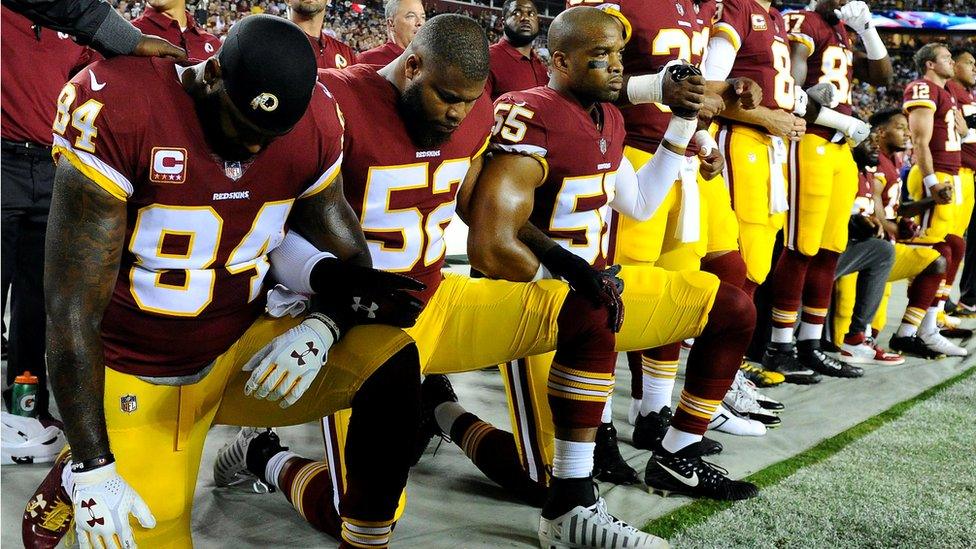 American footballers kneeling during the national anthem