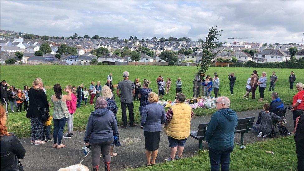 People observing a minute's silence on 16 August