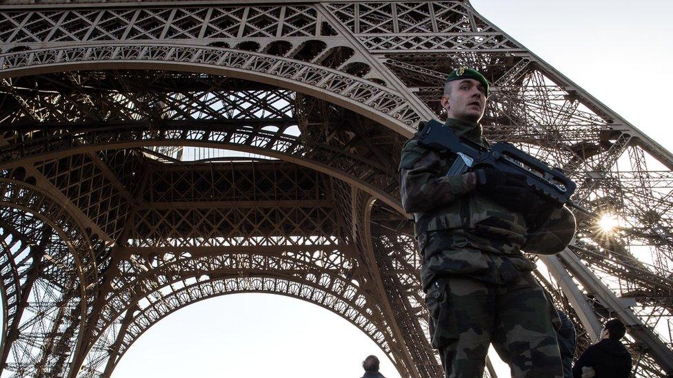 A French soldier stands guard at Eiffel Tower