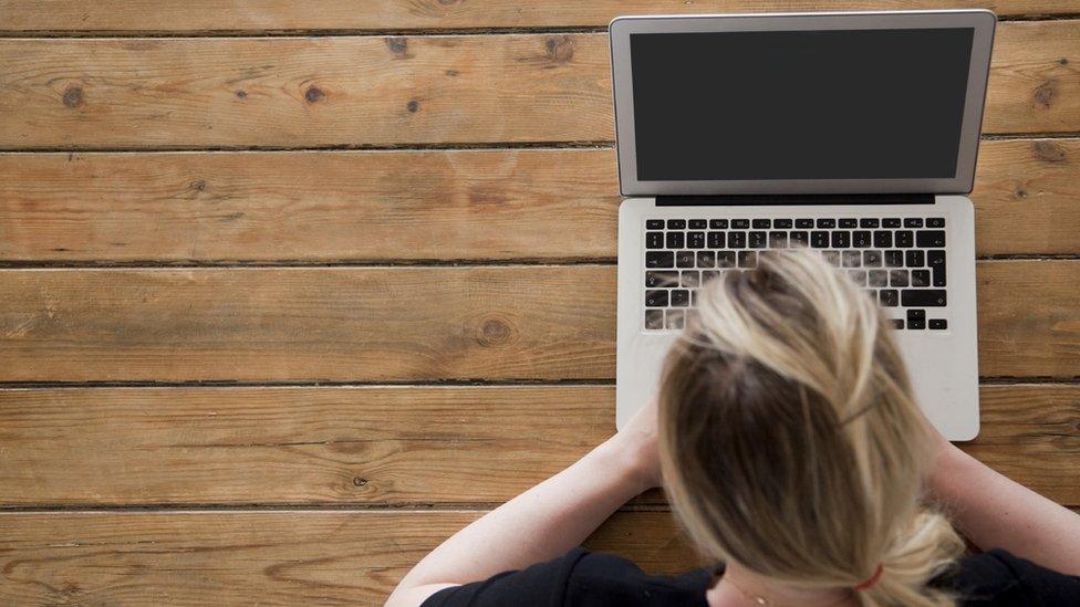 Overlooking woman on computer