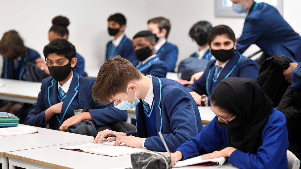 students with masks on in the classroom.