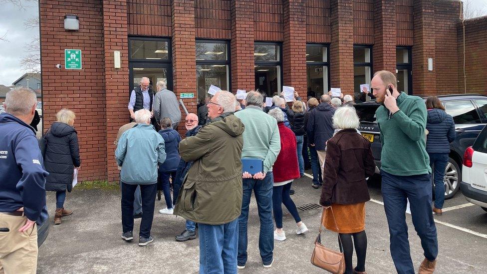 People standing outside a hall