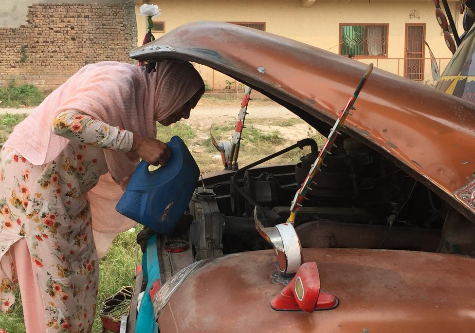 Shamim Akhtar looks under bonnet of truck