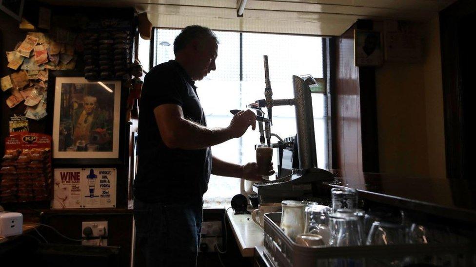 John Frances Carty pulls a pint in the Maypole Bar in Holywood, Northern Ireland