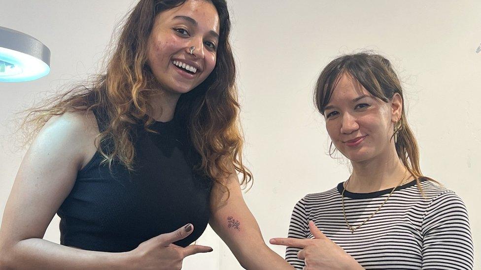 Natasha with a tattoo artist