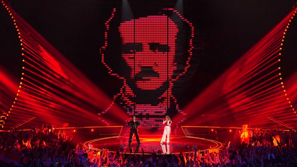 Austria's Teya & Salena in front of a giant picture of writer Edgar Allen Poe on a screen at Eurovision