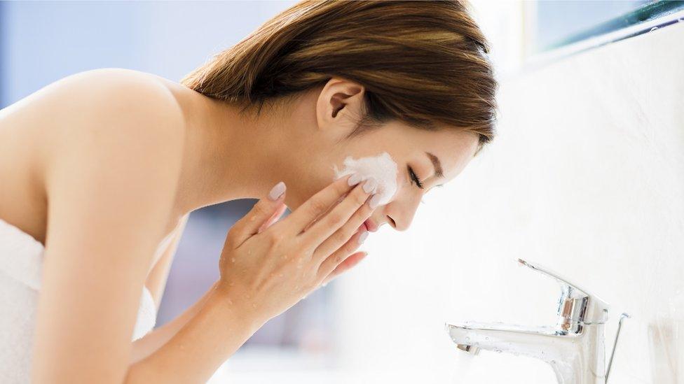 Woman washing her face