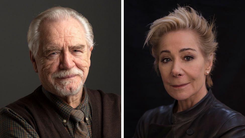 Professional headshot of Brian Cox and Zoe Wanamaker. Brian smiles at the camera, wearing a brown waistcoat over a brown and black checked shirt and brown tartan tie. He has white hear and a white goatee beard. Zoe has short blonde hair and black eyebrows, and wears a black leather jacket.