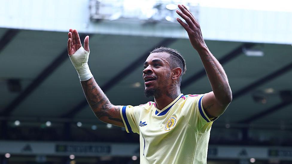 Juninho Bacuna with his arms up