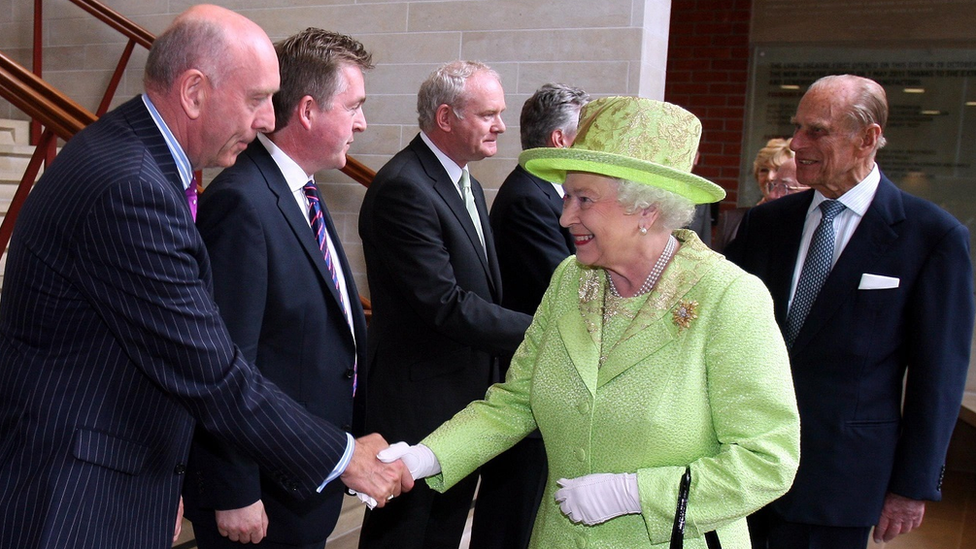 Queen Elizabeth II shakes hands with Peter Sheridan in Belfast in June 2012