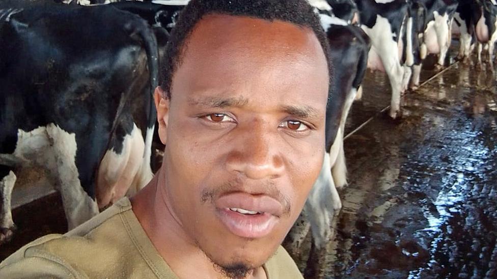 Tanzanian student Ezekiel Kitiku pictured at a dairy farm in Israel