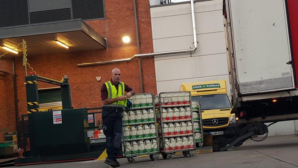 Tom delivering milk to a supermarket