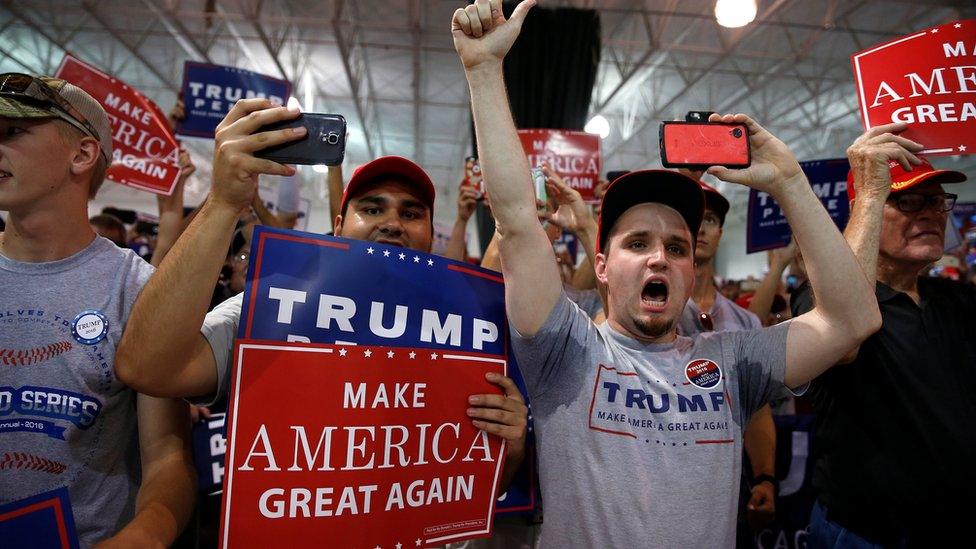 Supporters cheers as Republican presidential nominee Donald Trump walks on stage during a campaign event