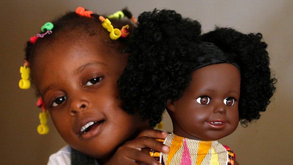 Aremou Karima, 3, holds a doll named Lola of Naima Dolls brand in Abidjan, Ivory Coast December 20, 2020. Picture taken December 20,