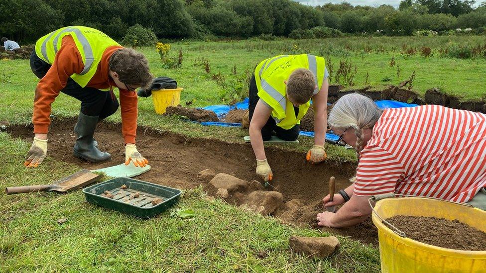 Volunteers excavating site