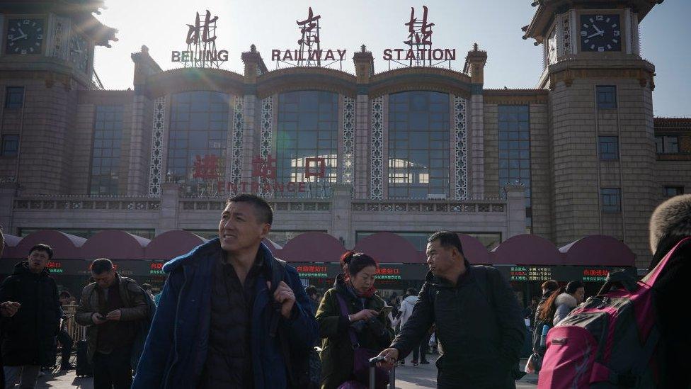 People walk in front of the entrance of Beijing Railway Station on January 19, 2020 in Beijing, China