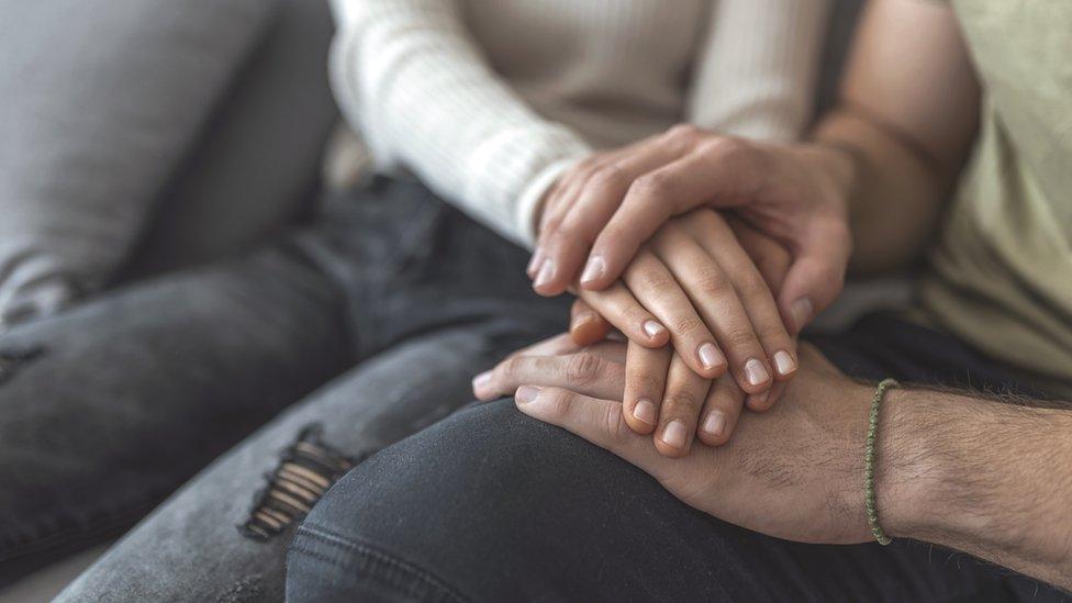 Couple holding hands