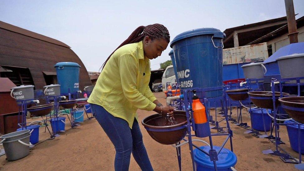 The BBC's Antonia Howard tests out a hands-free tap in Sierra Leone