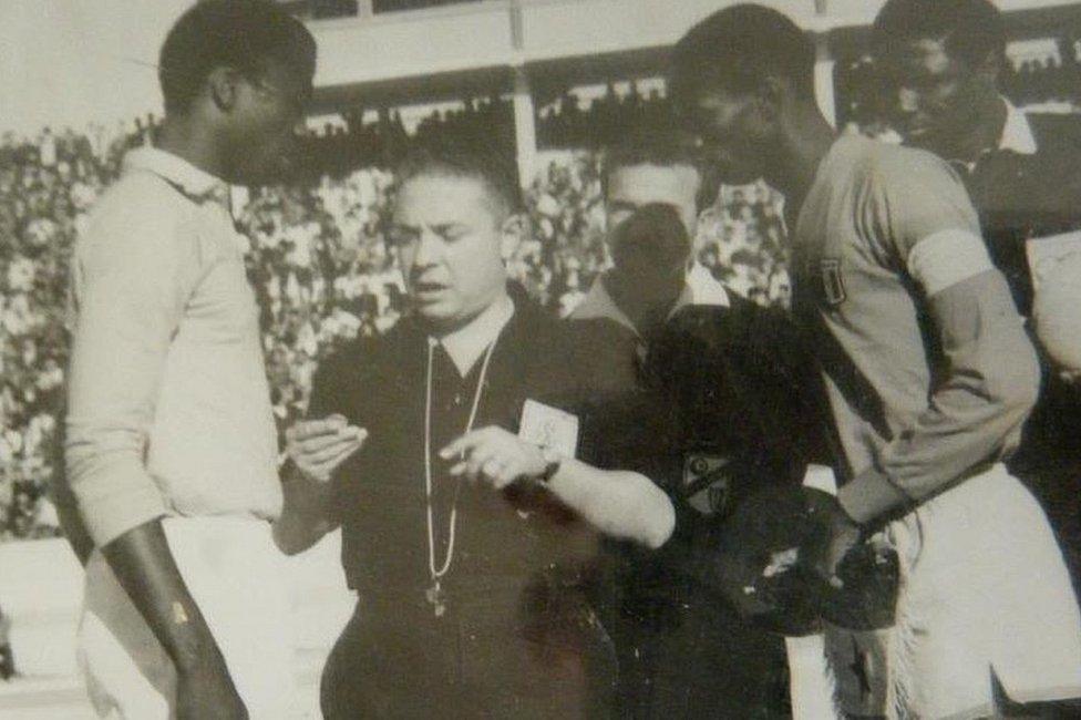 Referee talking to two players