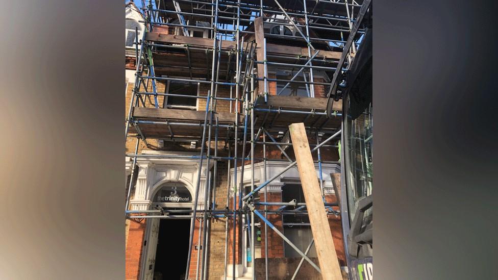 Former hotel building covered in scaffolding