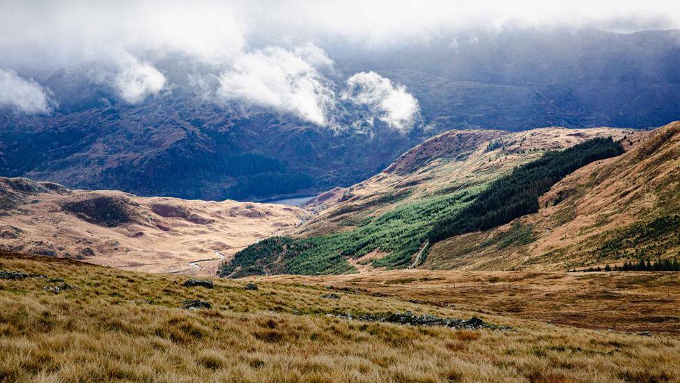 A look down into a valley in southern Scotland from up above the cloud line