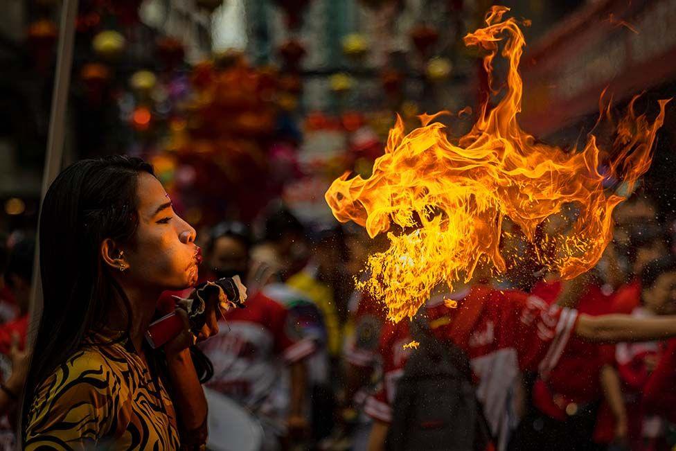 A performer breathes fire during Lunar New Year celebrations at Binondo district, in Manila, Philippines.