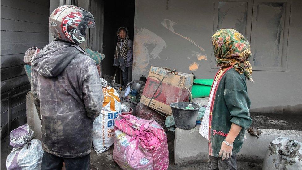 Residents collect their belongings as they evacuate from a village impacted by the Mount Sinabung eruption at Gamber Village, Simpang Empat, Karo, North Sumatra, Indonesia, 22 May 2016.