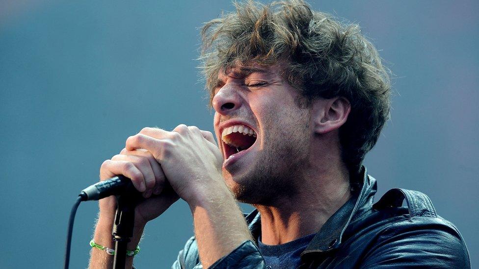 Paolo Nutini sings into a microphone