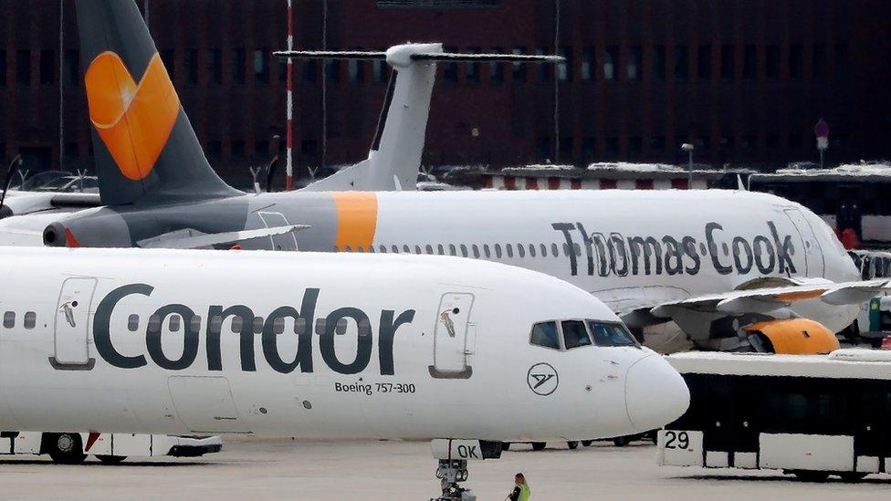 A Condor plane next to a Thomas Cook plane