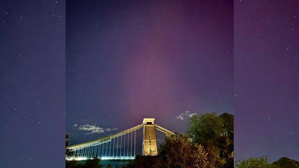 The Clifton Suspension Bridge with the Northern Lights in the night sky in the background