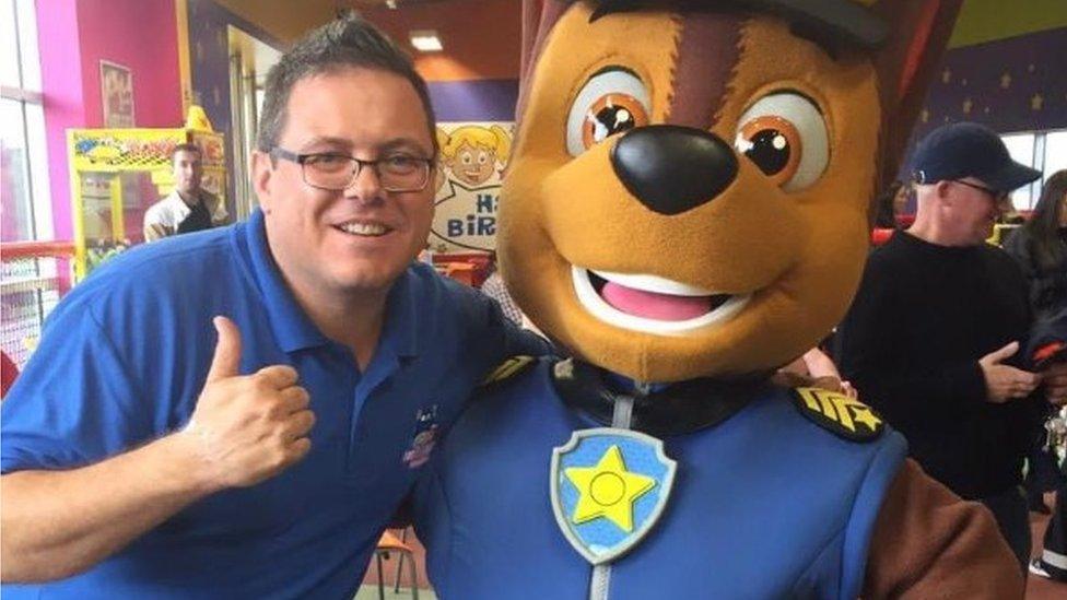 Jon Skelding posing with a Paw Patrol character