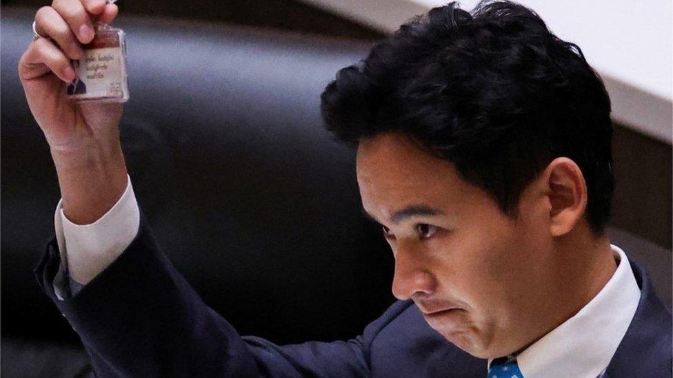 Pita Limjaroenrat, leader of the Move Forward Party holds up his ID card at parliament after Thailand"s Constitutional Court ordered his temporary suspension from the parliament, on the day of the second vote for a new prime minister, in Bangkok, Thailand, July 19, 2023.