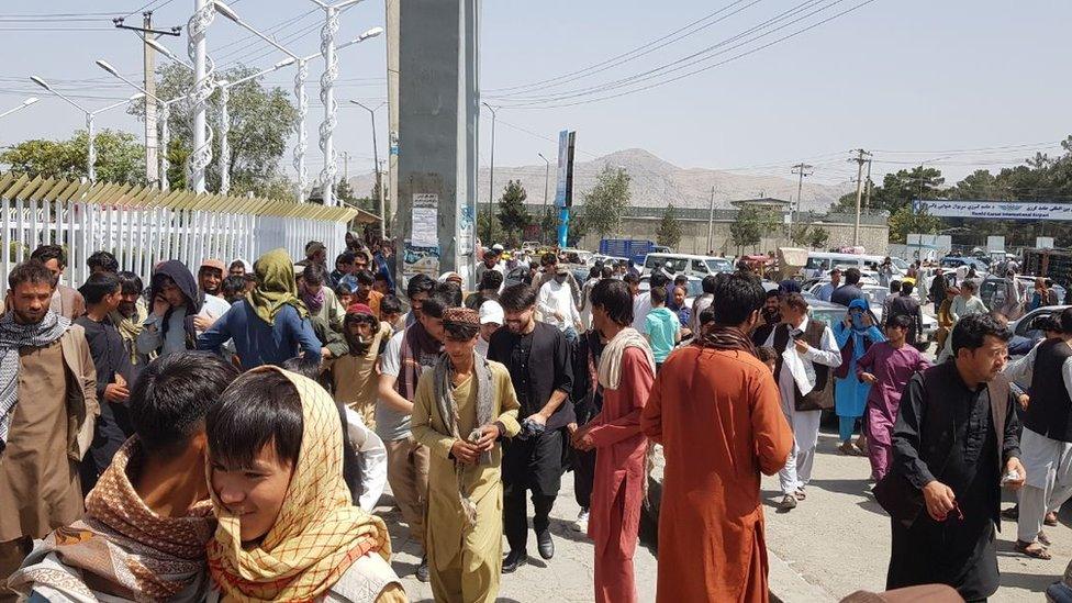 Thousands of Afghans rush to the Kabul International Airport as they try to flee the Afghan capital of Kabul