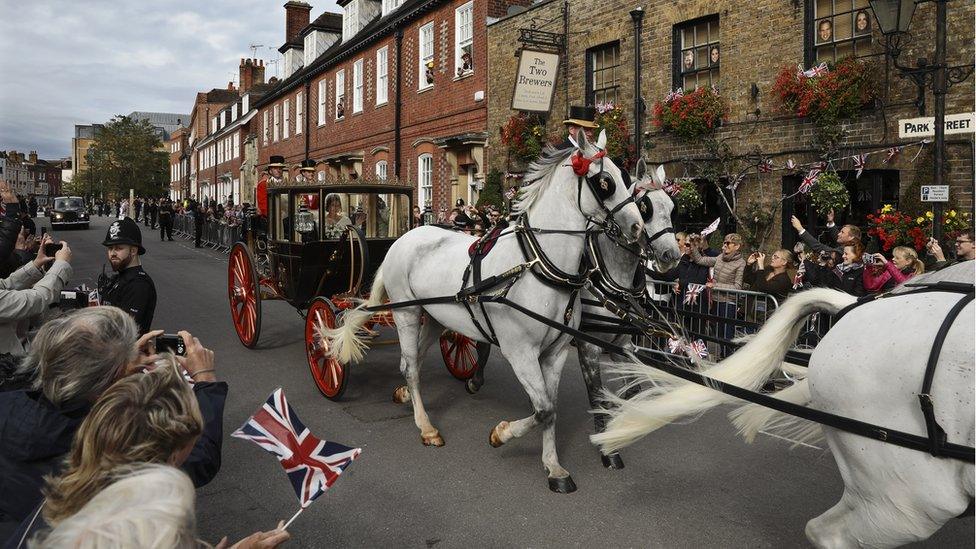 Newlyweds Princess Eugenie of York and Jack Brooksbank wave to the crowds from their carriage after their Royal wedding at St. George's Chapel