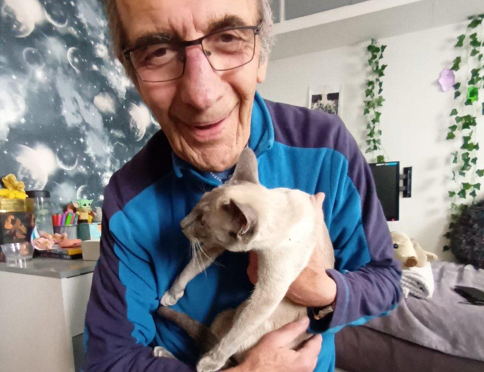 Dan Worsley holding Ashley the cat in his arms