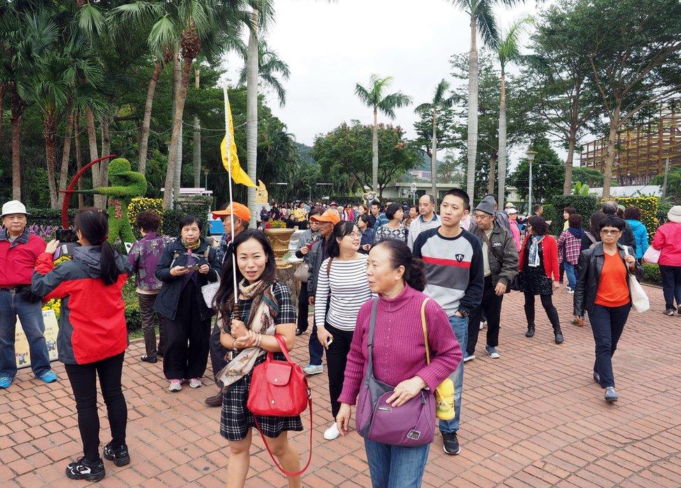 A guide (C-L) leads a Chinese tour group back to their coach after visiting historical Chinese political leader Chiang Kai-shek's former residence in Taipei, Taiwan, 29 November 2016.