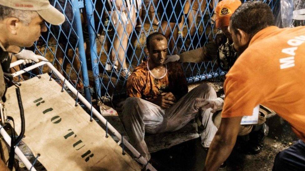 A man hurt by a float of the Paraiso do Tuiuti samba school during the first night of Rio's Carnival is assisted at the entrance of the Sambadrome in Rio de Janeiro, Brazil, on February 26, 2017.